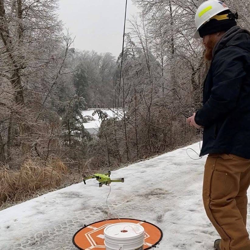 Drone view of electric cooperative distribution line work
